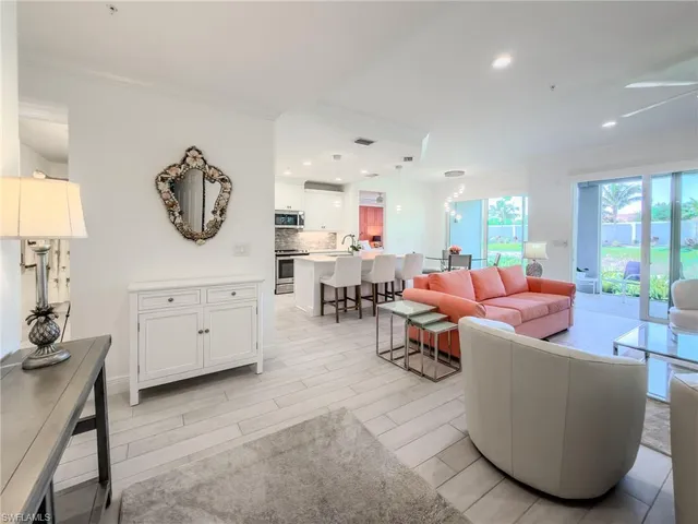 a living room with furniture a window and a table