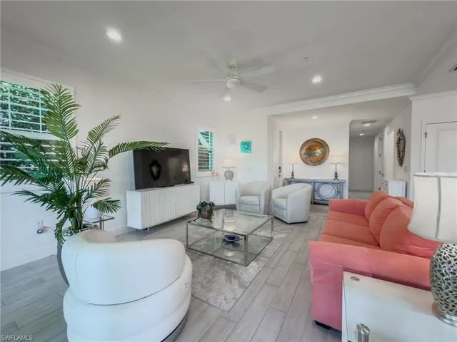 a living room with furniture and a potted plant