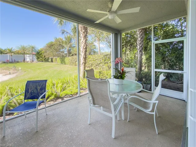 a dining room with furniture and a floor to ceiling window