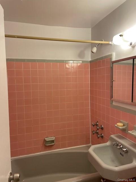 413 East 82nd Street, Unit 3A Manhattan, NY 10028 - Photo 4 of 10 a bathroom with a sink a shower and a mirror