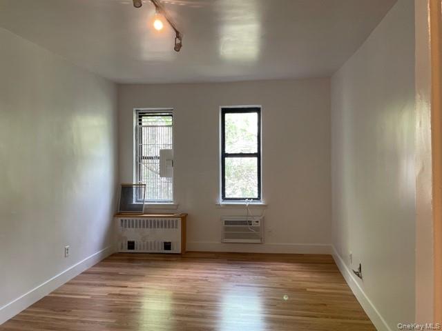 413 East 82nd Street, Unit 3A Manhattan, NY 10028 - Photo 6 of 10 an empty room with wooden floor and windows