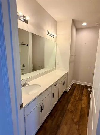 a spacious bathroom with a double vanity sink and a mirror