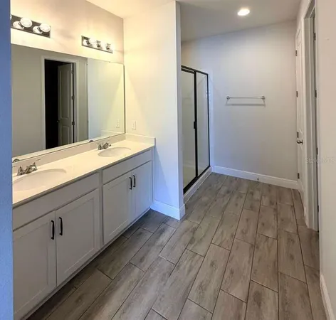 a spacious bathroom with a sink mirror and shower