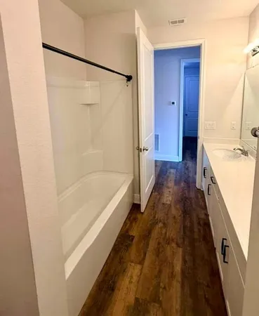 a bathroom with a bathtub and a shower