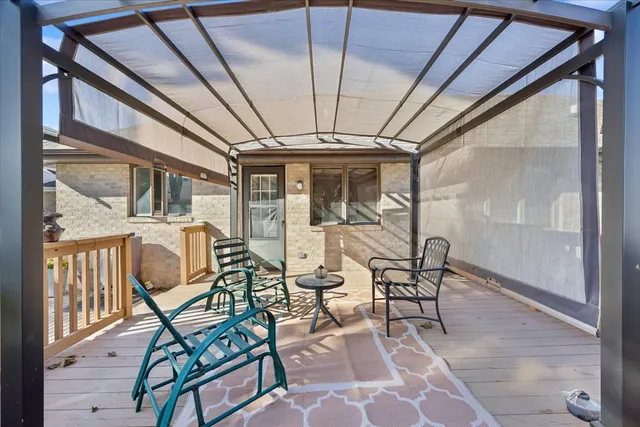 a view of a patio with table and chairs