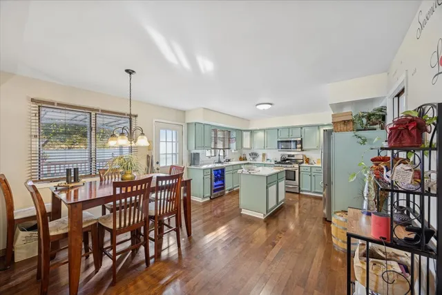 a room with lots of wooden furniture dining table and chairs