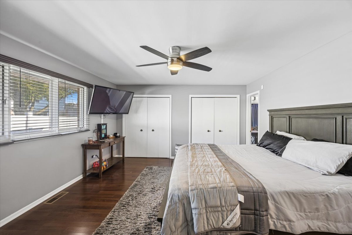 18311 Holland Road Lansing, IL 60438 - Photo 10 of 19 a bedroom with a bed and a chandelier