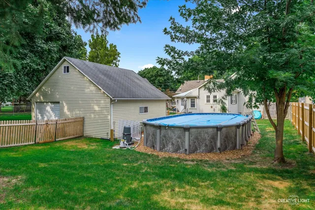 a view of a house with a backyard and a tub