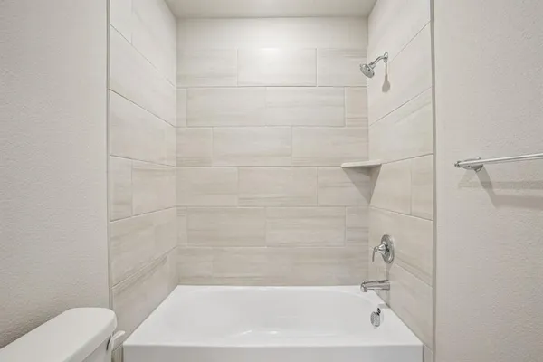 a bathroom with a bathtub and a toilet