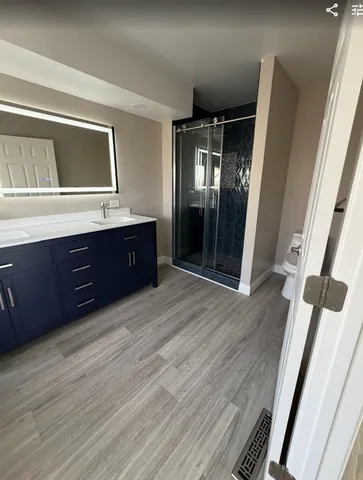 a spacious bathroom with a vanity and a mirror