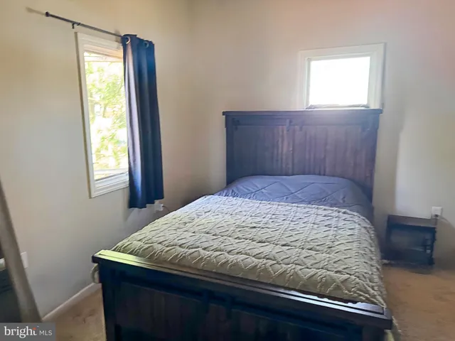 a bedroom with a bed and window