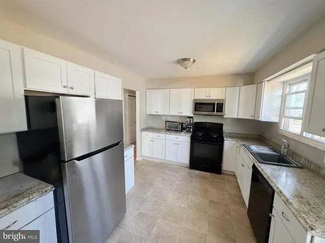 a kitchen with a refrigerator a sink and a stove