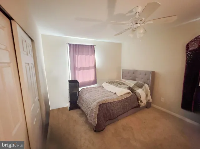 a bedroom with a bed and a mirror