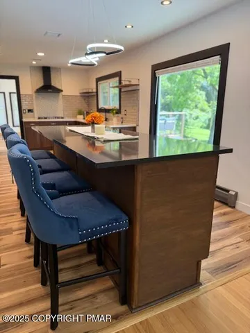 a room with stainless steel appliances kitchen island granite countertop furniture and a potted plant