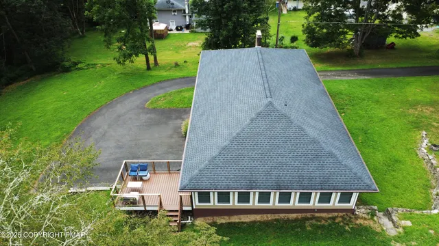 aerial view of a house with a yard