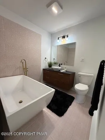 a bathroom with a sink a toilet and mirror