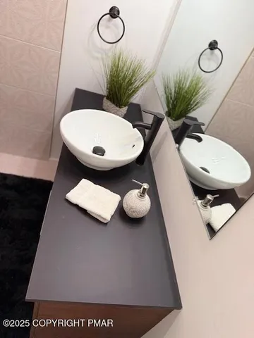 a bathroom with a sink mirror and toilet