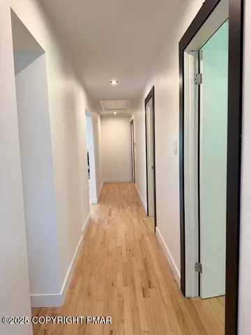 a view of hallway with wooden floor