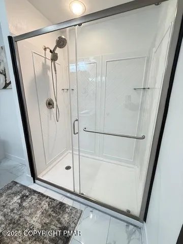 a bathroom with a glass shower door