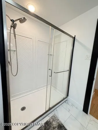 a bathroom with a glass shower door