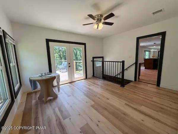 a view of a room with wooden floor and a window