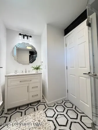 a room with a sink and a mirror