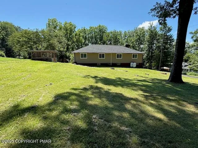 a front view of house with yard and green space
