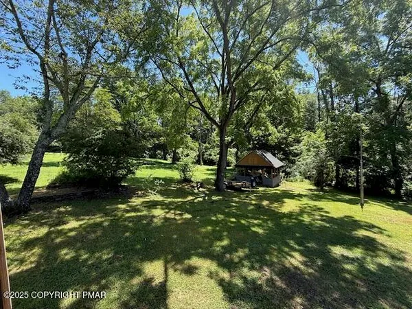 a backyard of a house with lots of green space