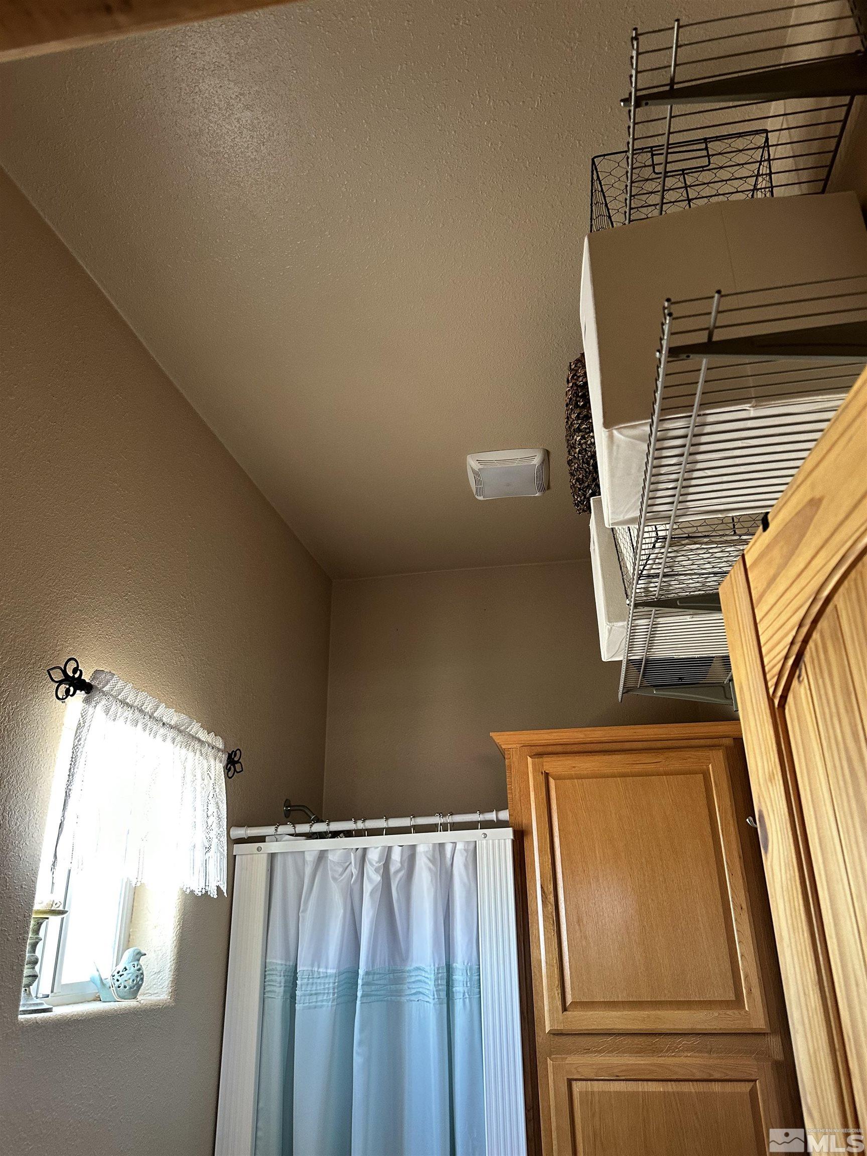 580 Silver Circle Tonopah, NV 89049 - Photo 13 of 37 a view of walk in closet with window and wooden floor