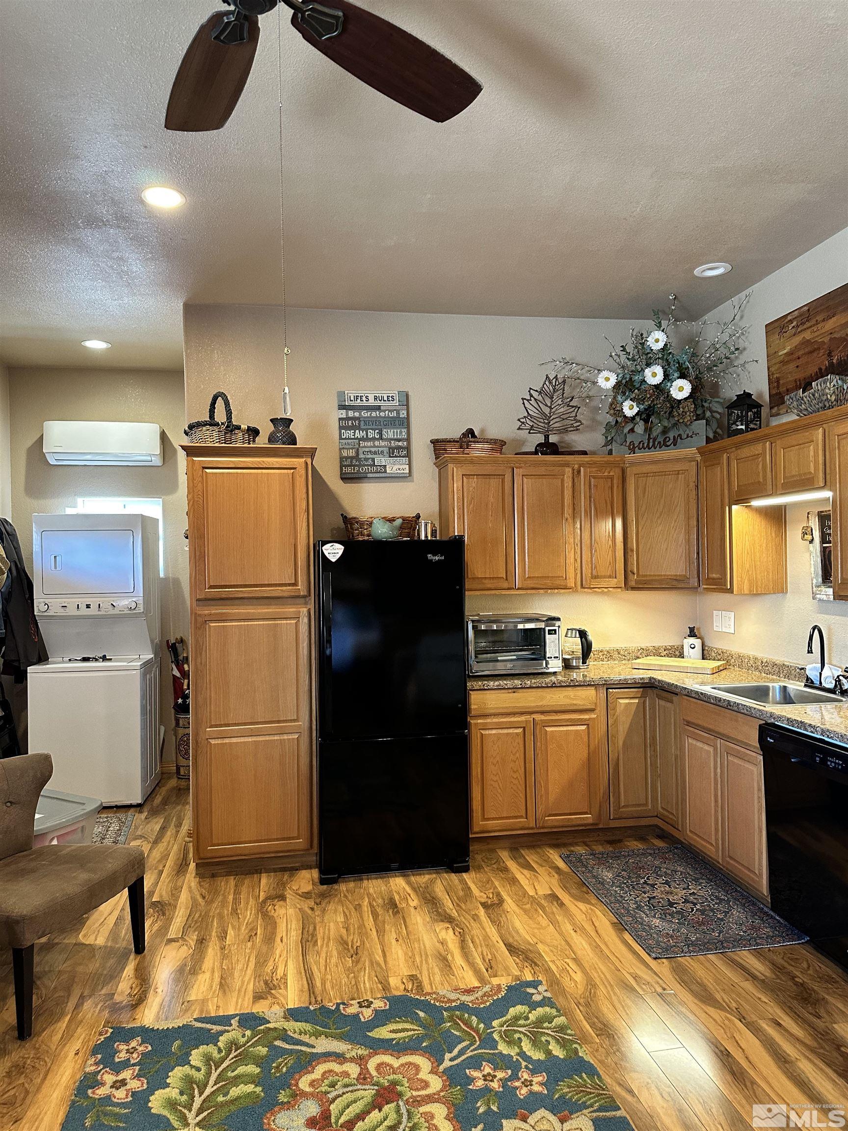 580 Silver Circle Tonopah, NV 89049 - Photo 20 of 37 a kitchen with refrigerator and cabinets