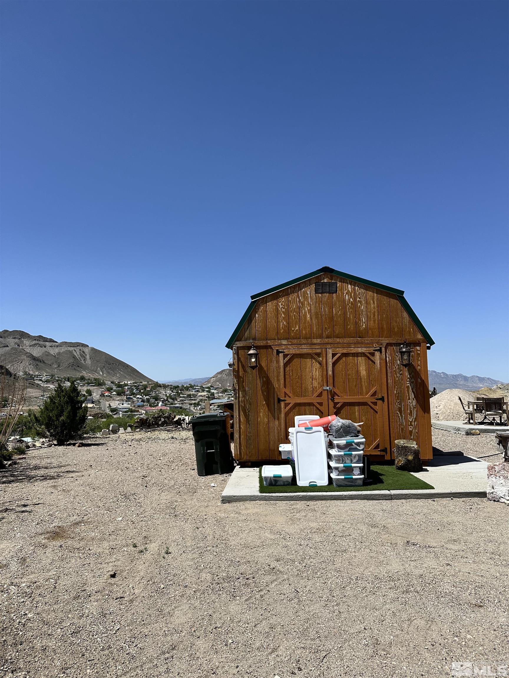 580 Silver Circle Tonopah, NV 89049 - Photo 6 of 37 a blue bench sitting in the middle of a road