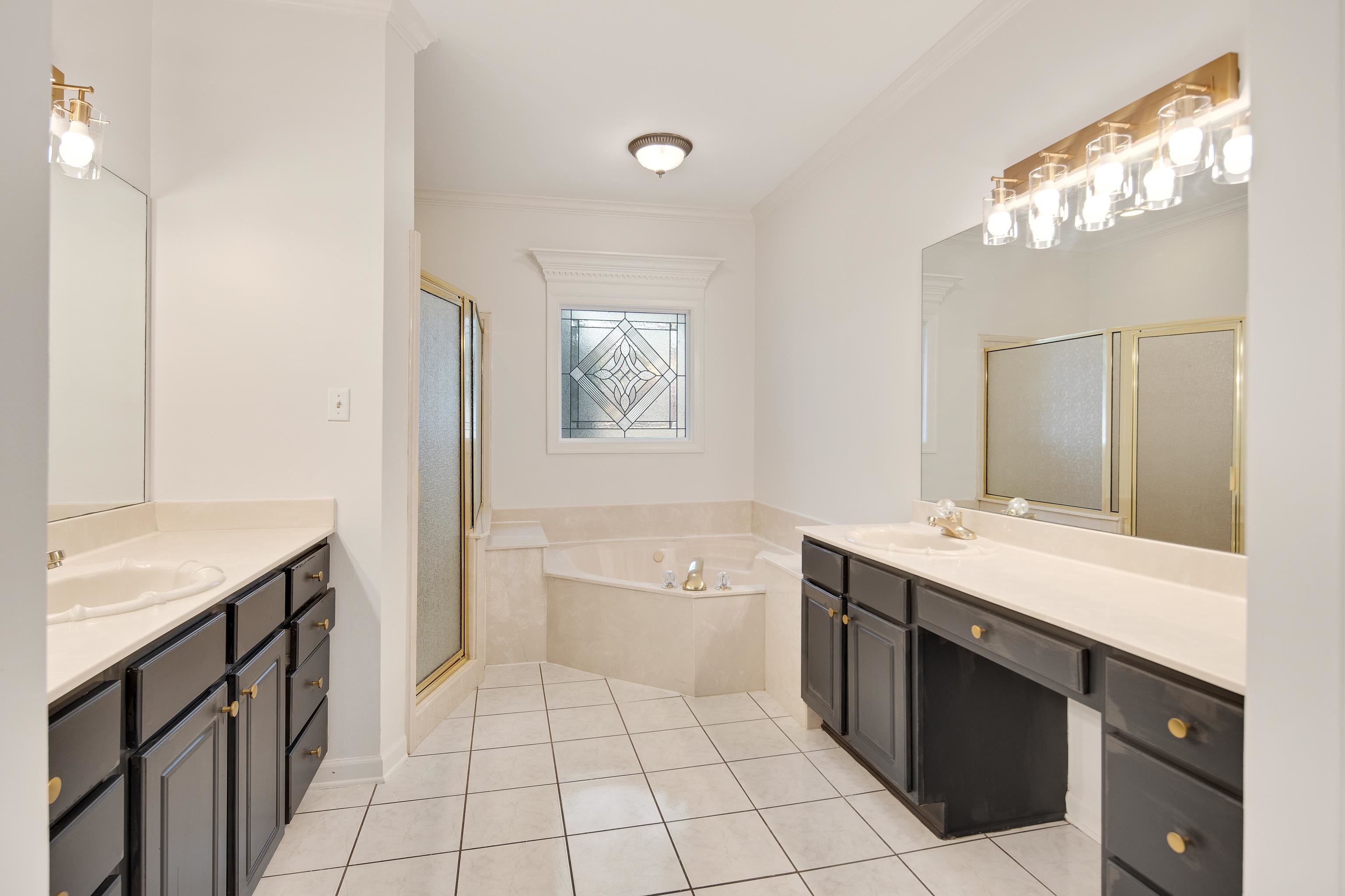 543 Estanaula Road Collierville, TN 38017 - Photo 19 of 37 a spacious bathroom with a bathtub sink and mirror