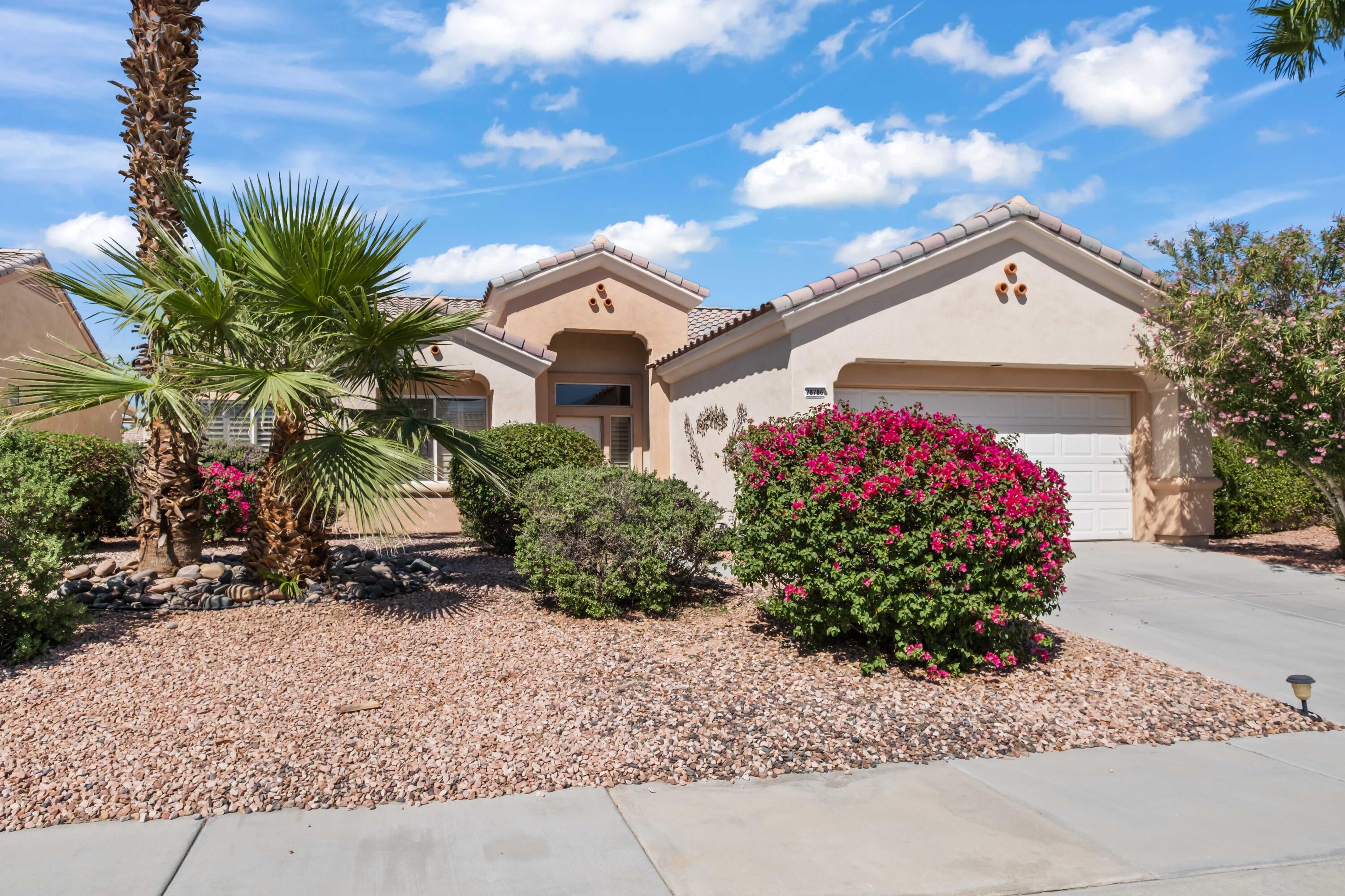 78786 Silver Lake Terrace Palm Desert, CA 92211 - Photo 1 of 20 a front view of a house with a yard