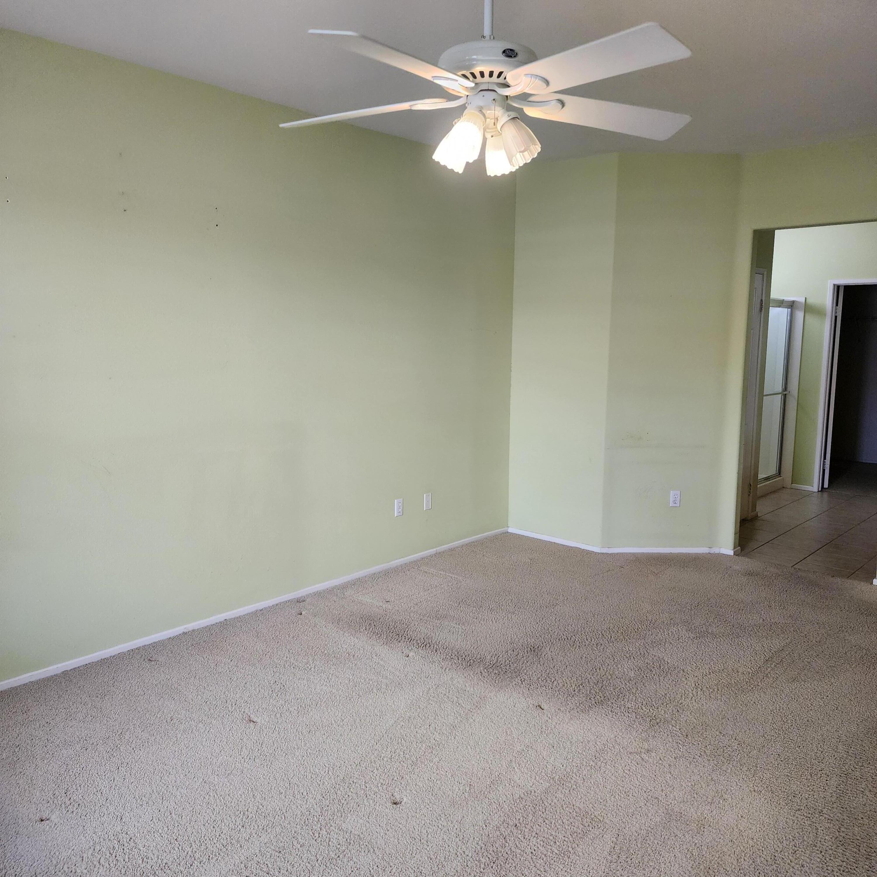 78786 Silver Lake Terrace Palm Desert, CA 92211 - Photo 11 of 20 an empty room with a chandelier fan and windows