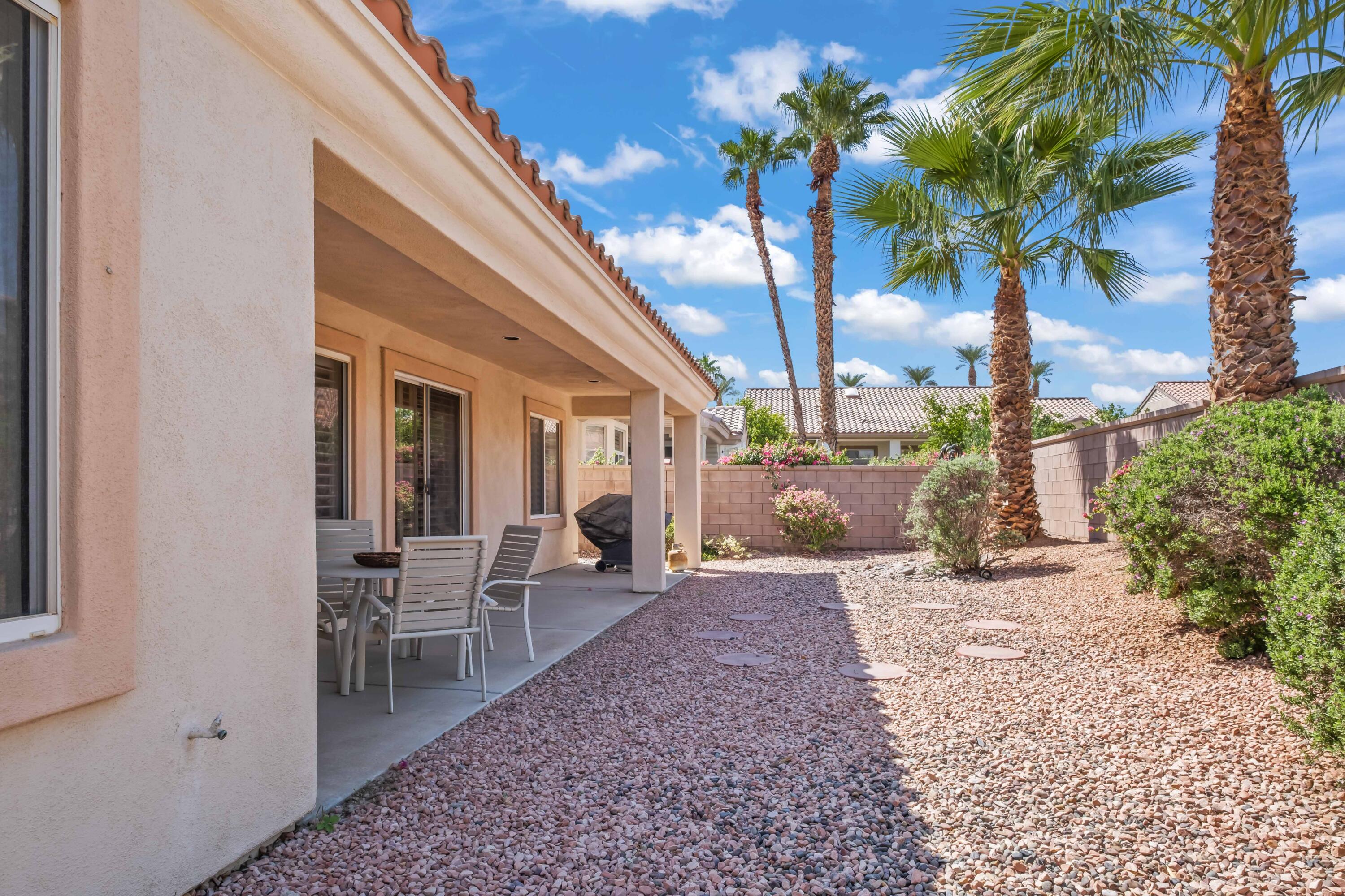 78786 Silver Lake Terrace Palm Desert, CA 92211 - Photo 15 of 20 a row of palm trees in front of a house