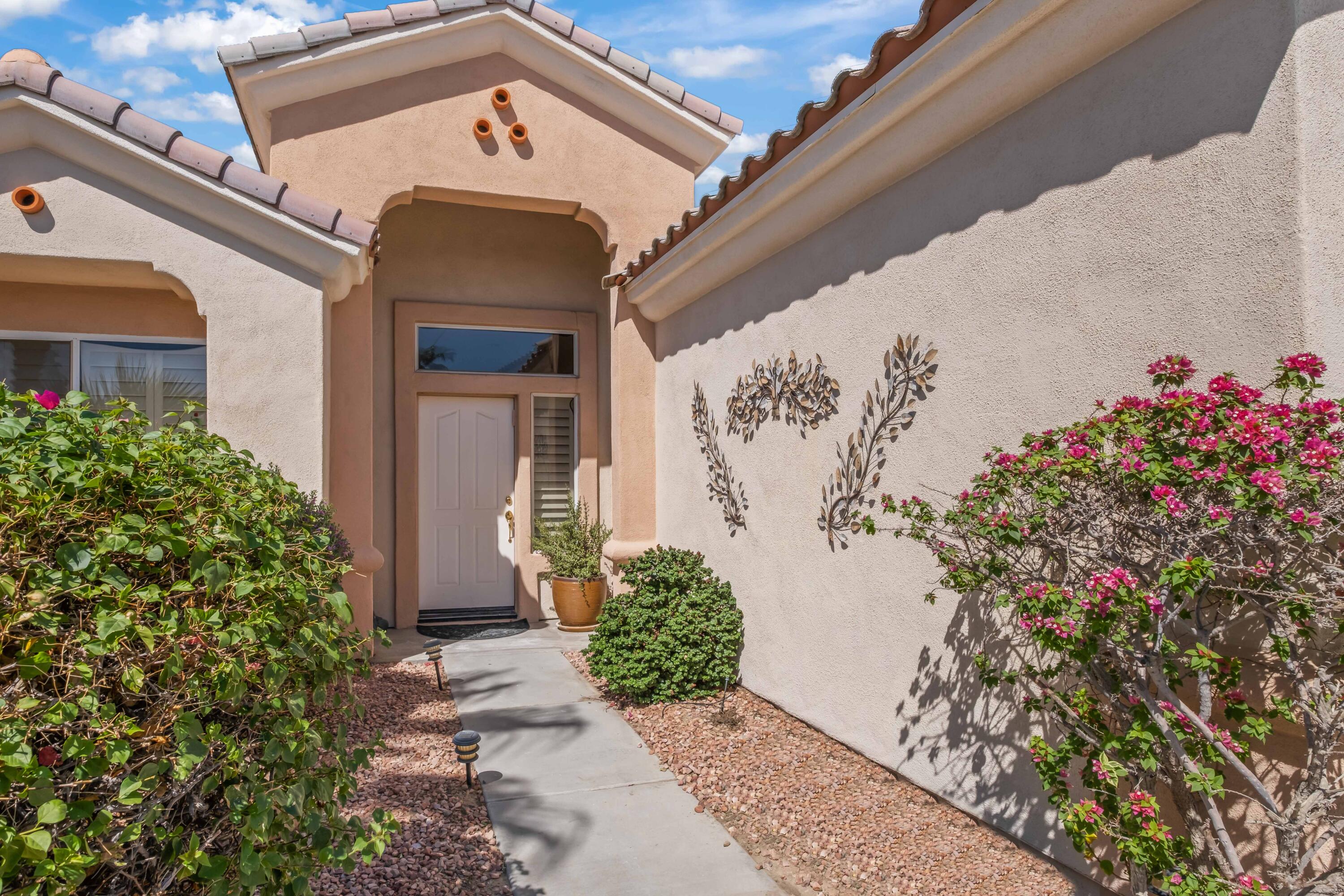78786 Silver Lake Terrace Palm Desert, CA 92211 - Photo 2 of 20 a front view of a house with a garage