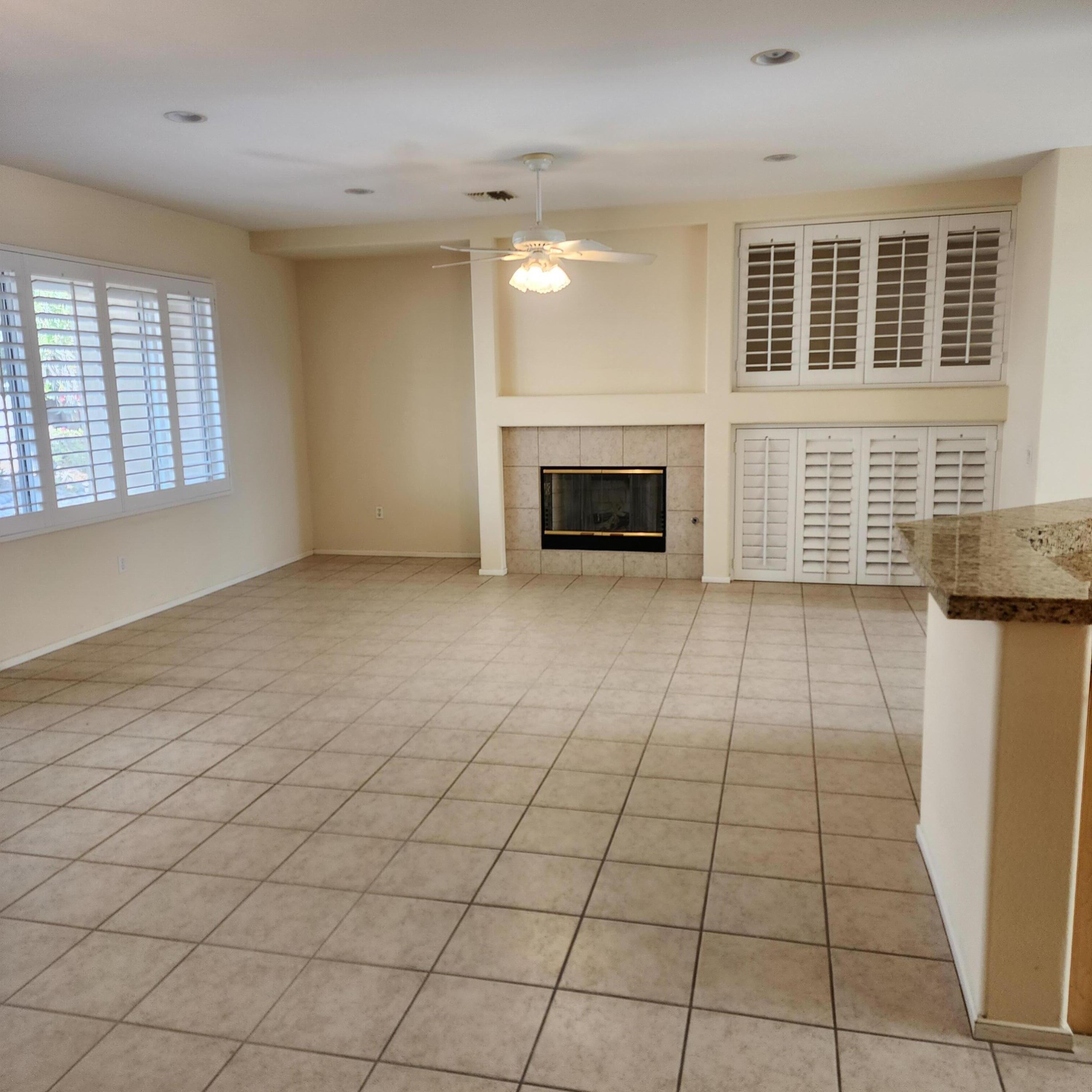 78786 Silver Lake Terrace Palm Desert, CA 92211 - Photo 6 of 20 a view of an empty room with a fireplace and a window