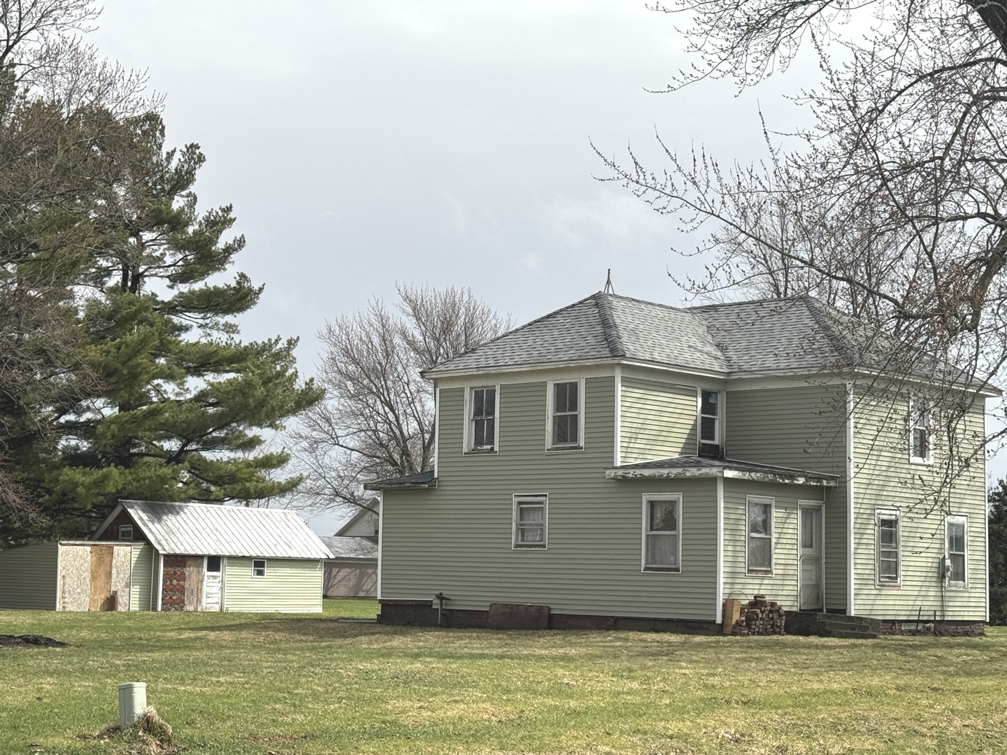 108 West 3rd Street Sublette, IL 61367 - Photo 2 of 4 a front view of a house with a garden and trees