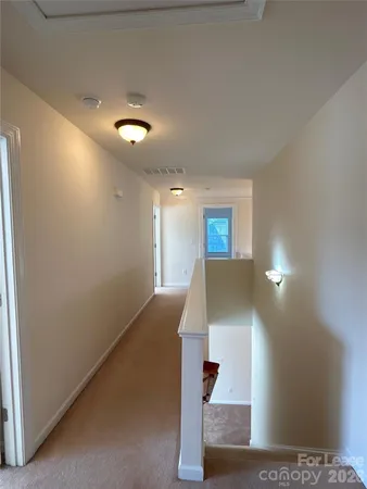 a view of a hallway with staircase
