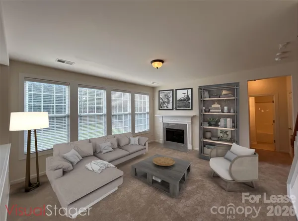 a living room with furniture and a fireplace