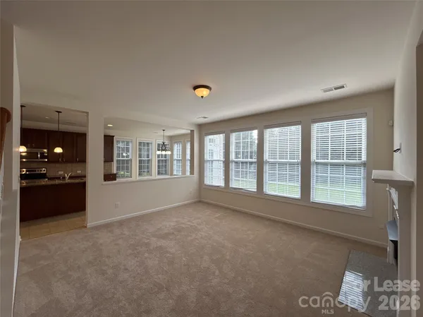 a view of an empty room with a kitchen