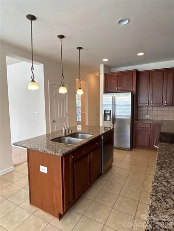 a kitchen with stainless steel appliances granite countertop a sink a counter space and cabinets