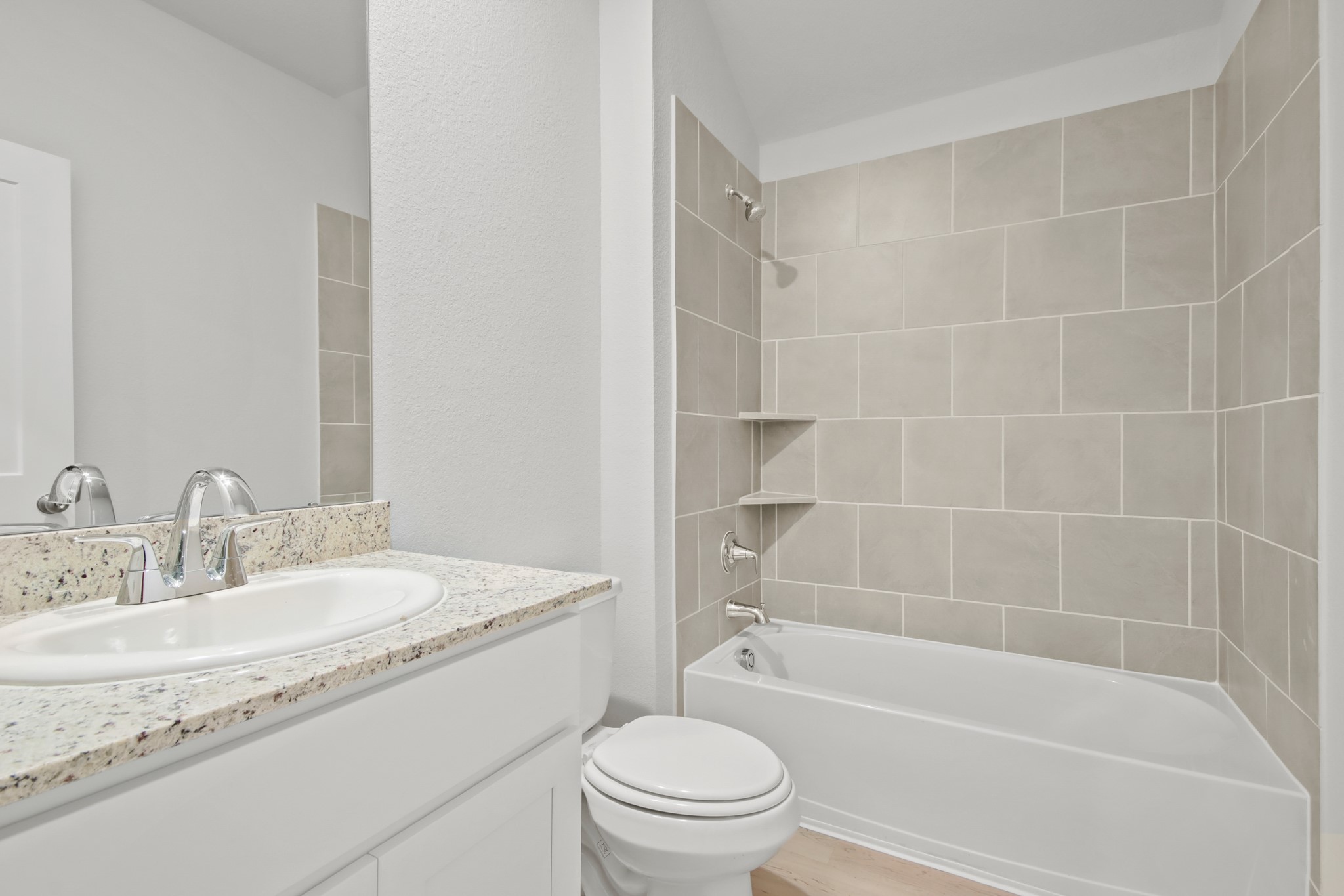 9715 Caney Bend Road Conroe, TX 77303 - Photo 17 of 24 a bathroom with a granite countertop toilet a sink and a bathtub