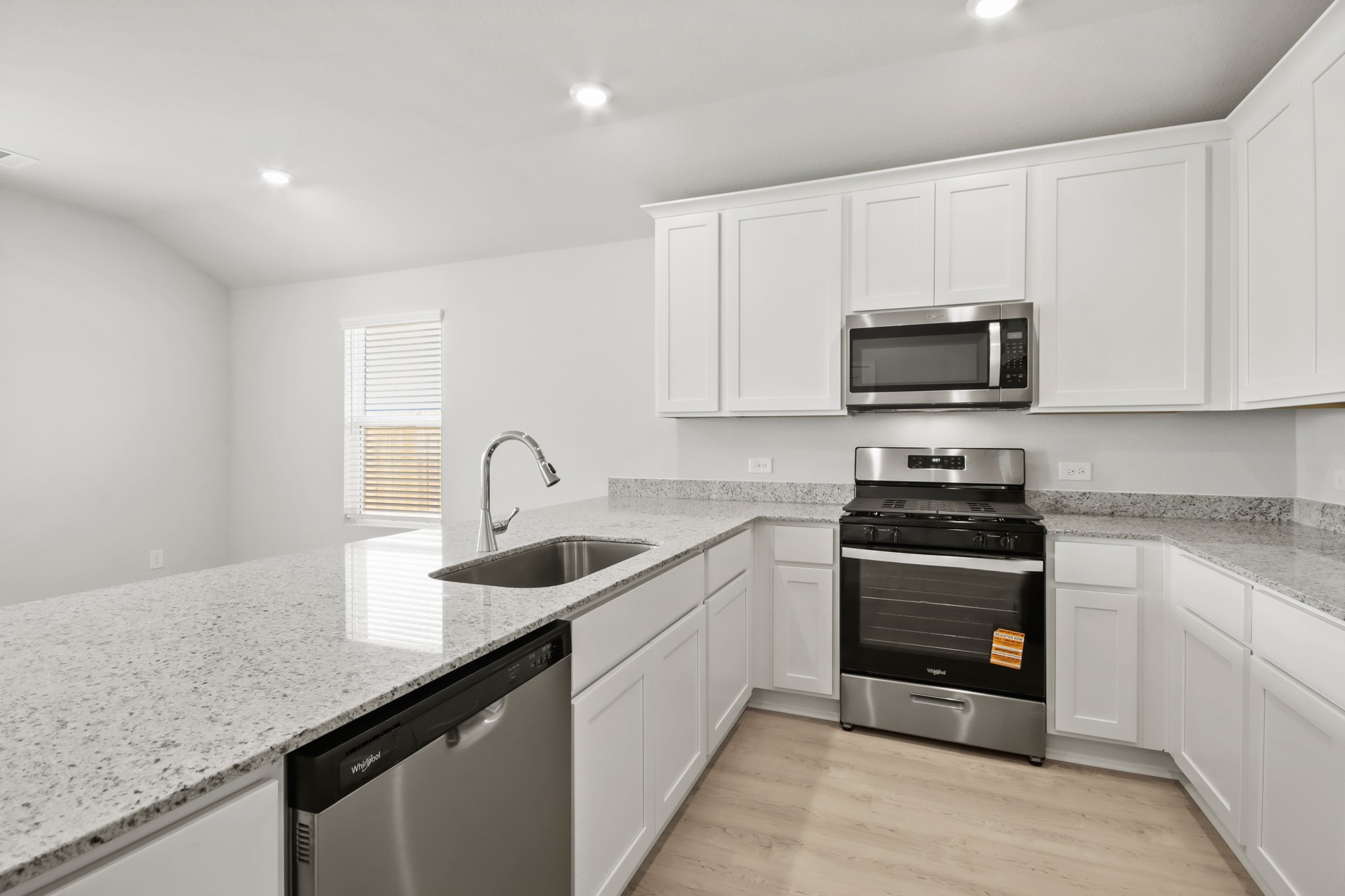 9715 Caney Bend Road Conroe, TX 77303 - Photo 4 of 24 a kitchen with sink a microwave and cabinets