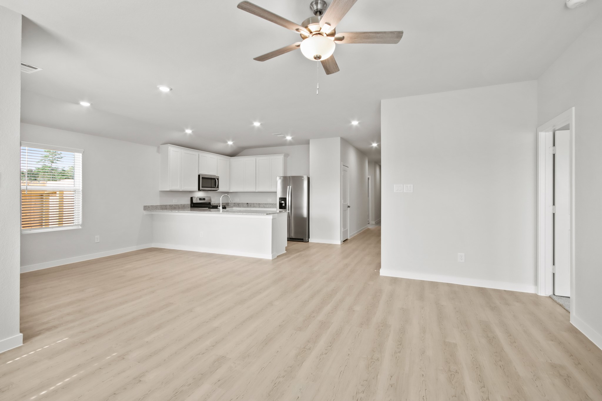 9715 Caney Bend Road Conroe, TX 77303 - Photo 7 of 24 a view of a kitchen with a sink and a refrigerator