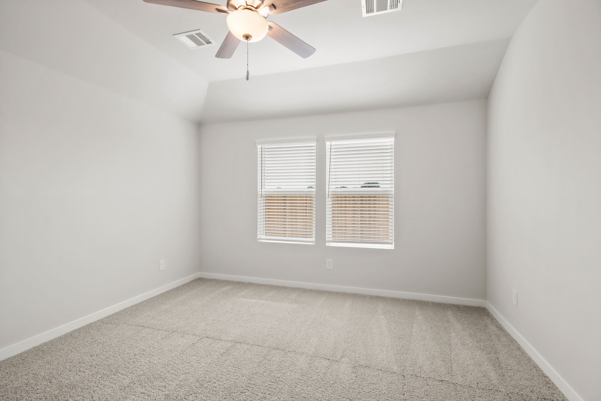 9715 Caney Bend Road Conroe, TX 77303 - Photo 9 of 24 an empty room with a window and a fan