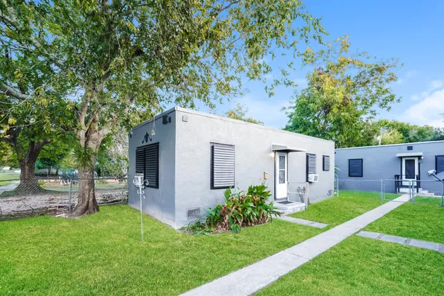 a front view of house with a garden