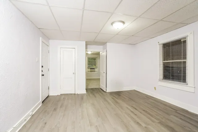 wooden floor in an empty room with a window