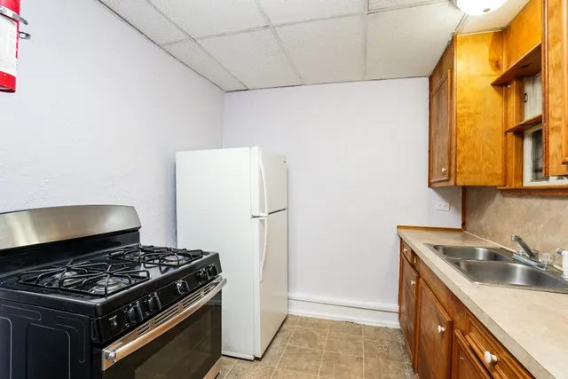 a kitchen with stainless steel appliances granite countertop a sink and a stove