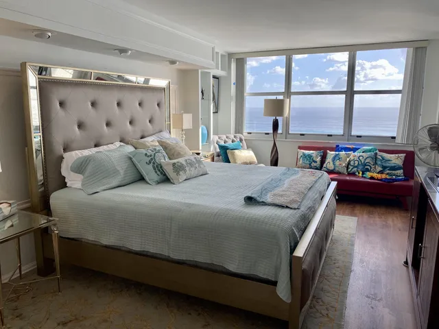 a bathroom with a sink a toilet a mirror and shower